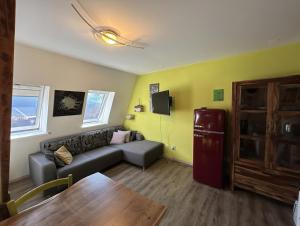 a living room with a couch and a refrigerator at Apartment Luna in Bovec