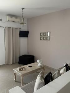 a living room with a couch and a table at Aegean Muses in Leipsoi