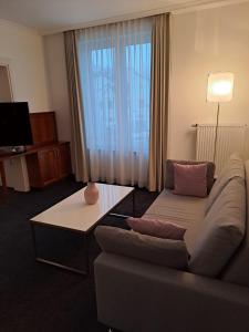 a living room with a couch and a table at Hotel & Apart4you in Dorfen