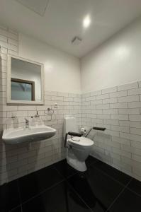 a bathroom with a toilet and a sink at Marbella in Ventspils +18 photos