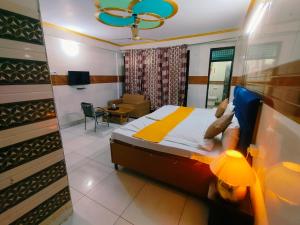 a bedroom with a bed and a living room at S D palace in Dighori