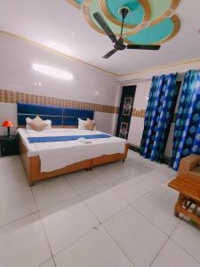 a bedroom with a bed and a ceiling at S D palace in Dighori