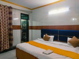 a bedroom with two beds with a blue headboard at S D palace in Dighori