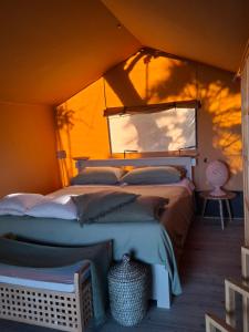 a bedroom with two beds in a tent at Oasi conca d'oro glamping in Noto