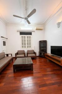 a living room with a couch and a flat screen tv at Davidduc Villa 30 Tay Ho in Hanoi