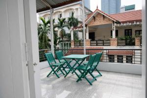 a table and chairs on the balcony of a building at Davidduc Villa 30 Tay Ho in Hanoi