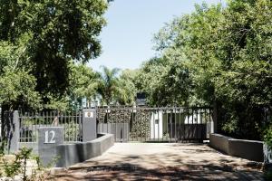 a driveway with a gate with the number on it at Kanaal kooi in Upington