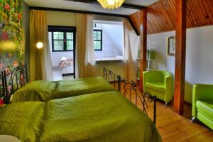 a bedroom with a green bed and two green chairs at Holiday home, oasis of peace, Polanow in Pollnow