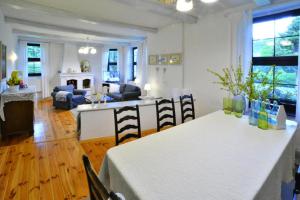 a kitchen and living room with a table and chairs at Holiday home, oasis of peace, Polanow in Pollnow