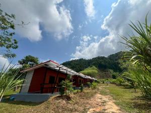 a small red and white house on a hill at Lanta Baan Suan Yoo Dee in Ban Nong Chaeng +2 photos