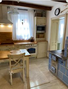 a kitchen with a table and a counter top at Chalupa Hlohovec in Hlohovec
