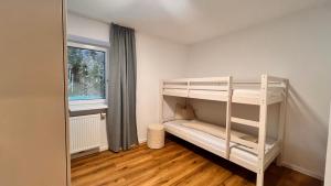 a bedroom with two bunk beds and a window at Apart Alm in Karrösten