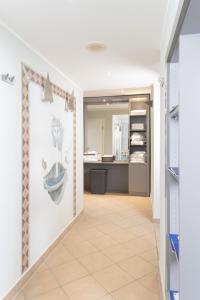 a hallway with a tile floor and a kitchen at Hotel Haus Gimken in Essen +23 photos