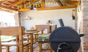 a grill in a living room with a table and chairs at Chalupa Hlohovec in Hlohovec +5 photos