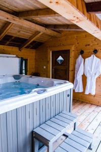 a large jacuzzi tub in a wooden house at Salzbergalm in Berchtesgaden