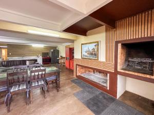 a room with a dining table and a fireplace at Ganstever Suiderstrand Western Cape in Suiderstrand