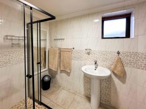 a bathroom with a sink and a shower at Ganstever Suiderstrand Western Cape in Suiderstrand +64 photos