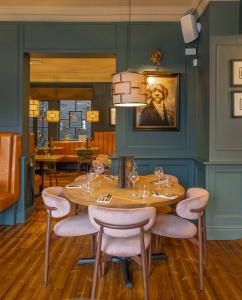 a dining room with a wooden table and chairs at The Wheatsheaf Hotel, Sandbach in Sandbach