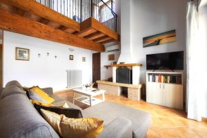 a living room with a couch and a tv at Casamorena in Montegabbione