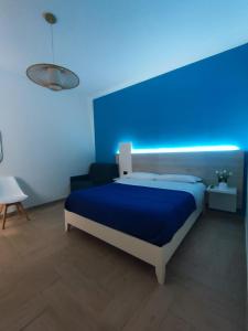 a blue bedroom with a bed with a blue wall at Stefanelli Tropea Home in Tropea
