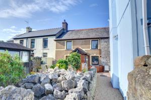 a stone wall in front of a house at 2 Bed in Porthcawl oc-way245 in Porthcawl