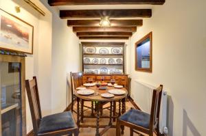 a dining room with a wooden table and chairs at 2 Bed in Porthcawl oc-way245 in Porthcawl