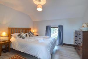 a bedroom with a bed and a dresser and a window at 2 Bed in Porthcawl oc-way245 in Porthcawl