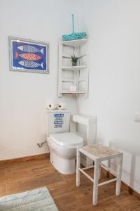 a bathroom with a white toilet and a stool at Beachfront two bedrooms house Casa Toral in Majanicho +51 photos