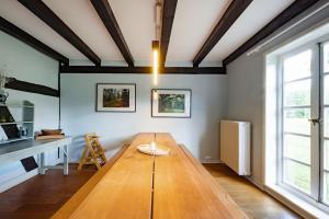 a living room with a wooden table and a desk at Haus im Wald in Gartow +41 photos