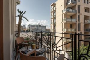 a balcony with chairs and a table on a balcony at Maison DADA in Beirut