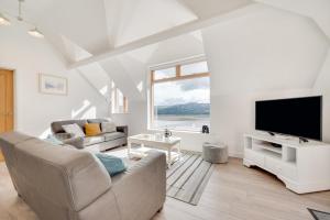 a living room with a couch and a tv at 2 Bed in Aberdyfi oc-wah694 in Aberdyfi