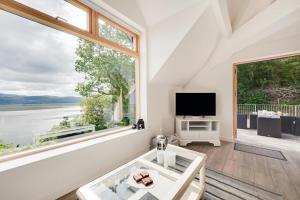 a living room with a large window and a tv at 2 Bed in Aberdyfi oc-wah694 in Aberdyfi