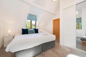 a bedroom with a large bed with blue pillows at 2 Bed in Aberdyfi oc-wah694 in Aberdyfi