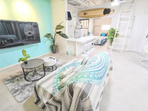 a living room with a bed and a sink at アンドスティ鴨川 in Kamogawa