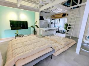 a large bedroom with a large bed and a sink at アンドスティ鴨川 in Kamogawa