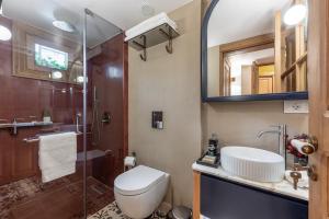 a bathroom with a toilet and a shower and a sink at Maison DADA in Beirut +44 photos