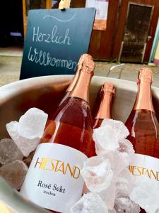 three bottles of beer in a bucket of ice at Hiestand's Gästehaus - Weingut & Hofbrennerei in Guntersblum +21 photos