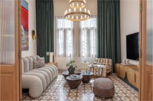 a living room with a couch and a tv at Maison DADA in Beirut
