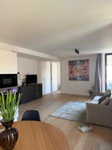 a living room with a table and a couch at Live Lugano - Via Muggina in Viganello