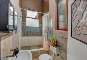 a bathroom with a sink and a shower and a toilet at Harbour House Mossel Bay - near sea & activities in Mossel Bay +37 photos