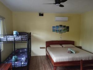a bedroom with two bunk beds and a fan at Dom's Oase in Panglao Island +42 photos