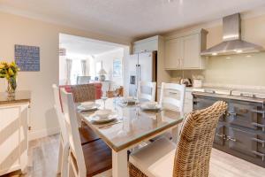a kitchen and dining room with a table and chairs at 2 Bed in Langland oc-hh193 in Newton