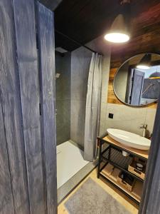 a bathroom with a shower and a sink and a mirror at Модрина Космач ko kosmach in Kozmacz