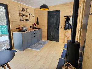 a kitchen with a stove in the middle of a room at Модрина Космач ko kosmach in Kozmacz +18 photos