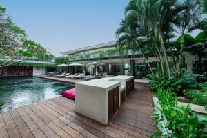 a resort with a swimming pool and a building at The Muse Luxury Eco-Living in Munggu