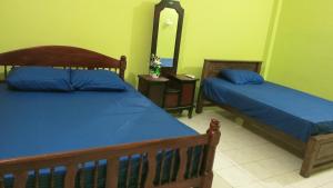 a bedroom with two beds and a mirror in it at Pasindu Garden in Vavuniya
