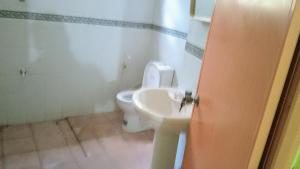 a bathroom with a toilet and a sink at Pasindu Garden in Vavuniya