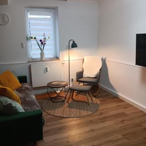 a living room with a couch and a chair at Ferienwohnung Grünes Leben in Simmerath