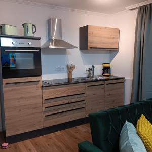 a kitchen with a sink and a stove top oven at Ferienwohnung Grünes Leben in Simmerath +5 photos