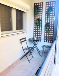 two chairs and a table on a porch at Homey Edessa Loft in Edessa